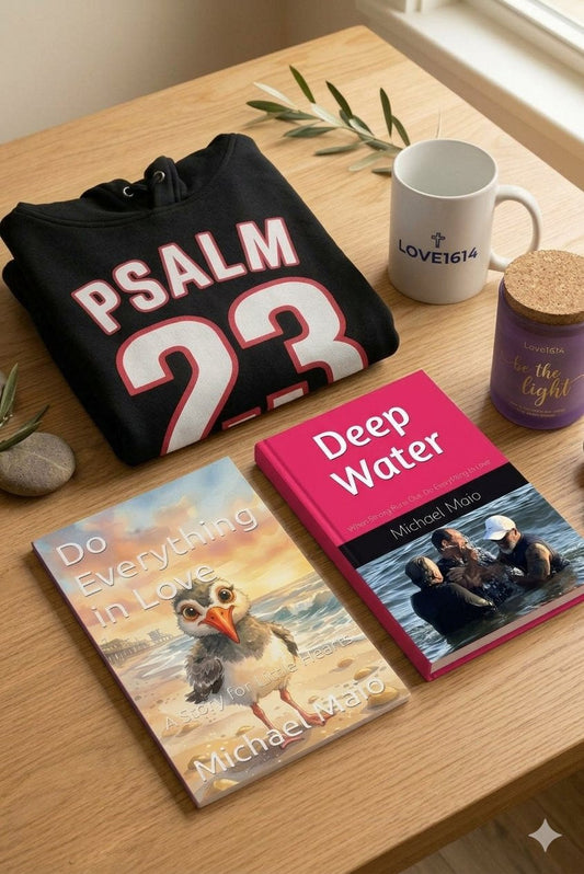 Love1614 products arranged together including hoodie, book, journal, mug, and candle on a natural surface