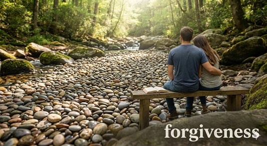 couple sitting on wooden bench by forest stream with open Bible forgiveness Christian faith
