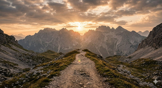 A solitary path stretching into a rugged landscape with warm morning light, symbolizing courage and faith