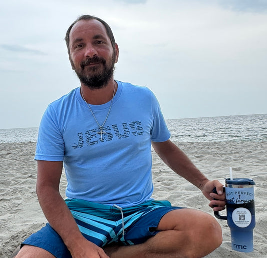 Man on beach wearing blue 66 Books of the Bible shirt by Love1614