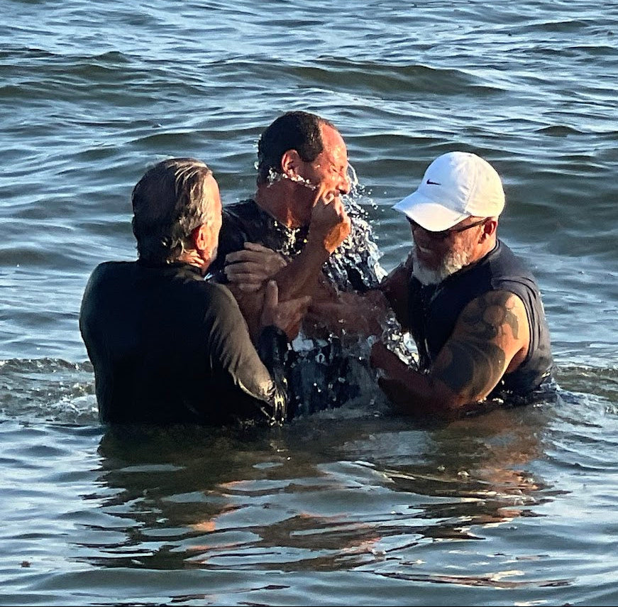 Love1614 founder Michael Maio ocean baptism in Long Beach New York surrounded by faith community