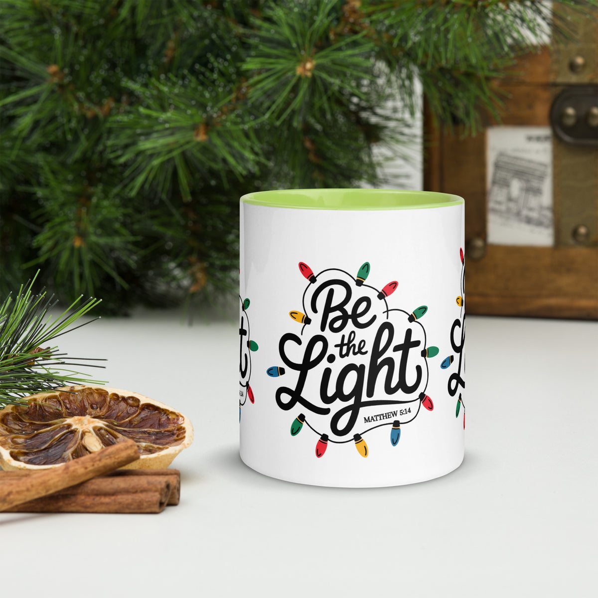 Be The Light Christmas Mug with green handle, Christmas scene lifestyle shot